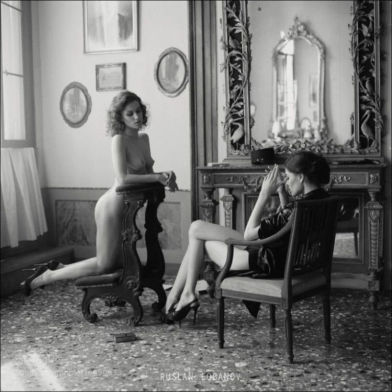 Naked woman with semi-clad woman