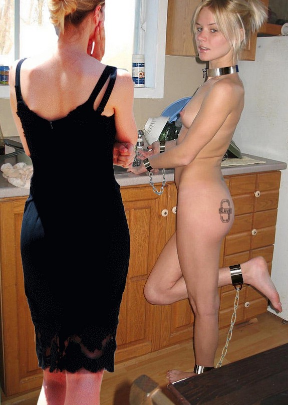 Naked woman in chains doing housework